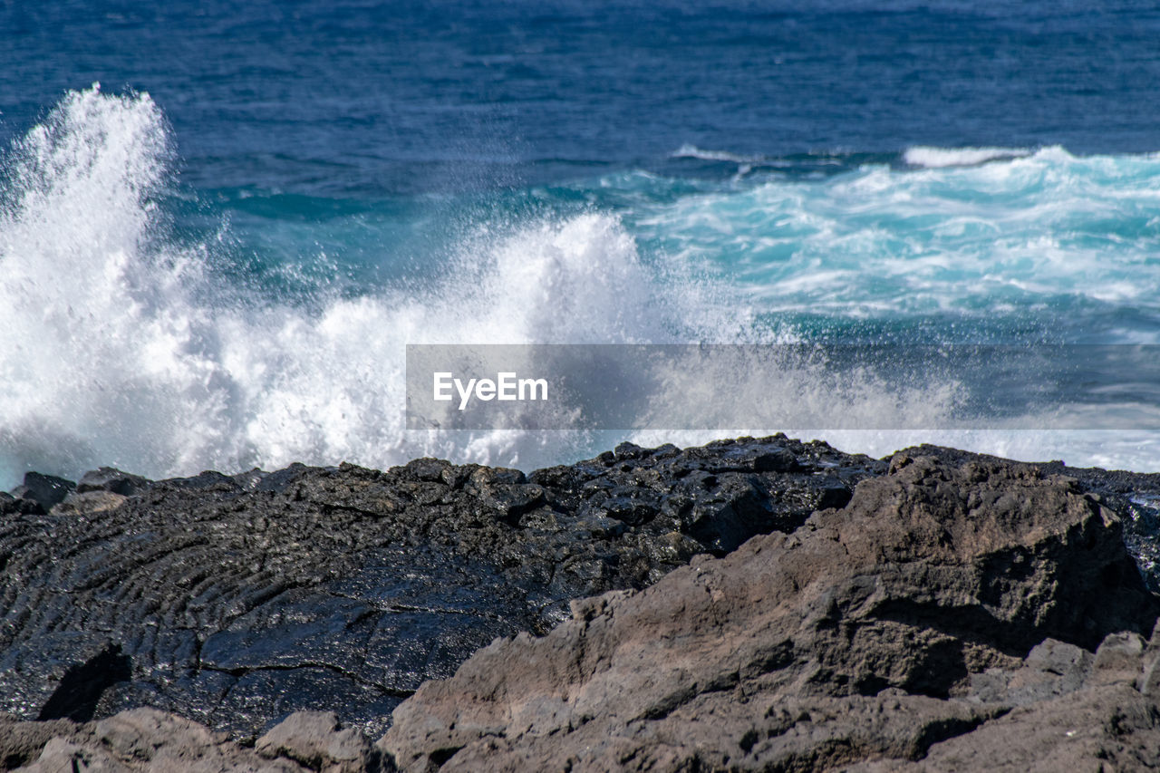 sea, motion, water, wave, rock, shore, breaking, beauty in nature, power in nature, beach, land, wind wave, coast, ocean, sports, splashing, scenics - nature, nature, hitting, no people, water sports, rough, terrain, body of water, day, cliff, outdoors, rock formation, force