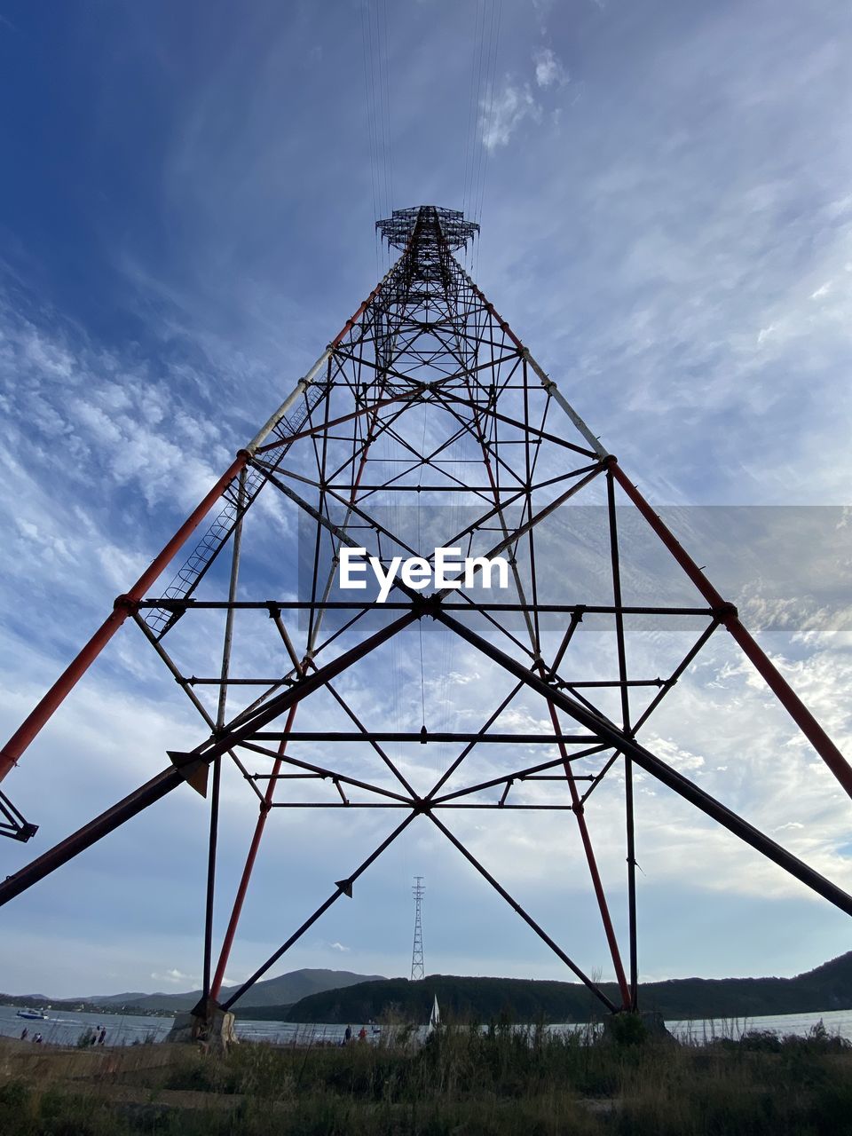 Low angle view of electricity pylon against sky