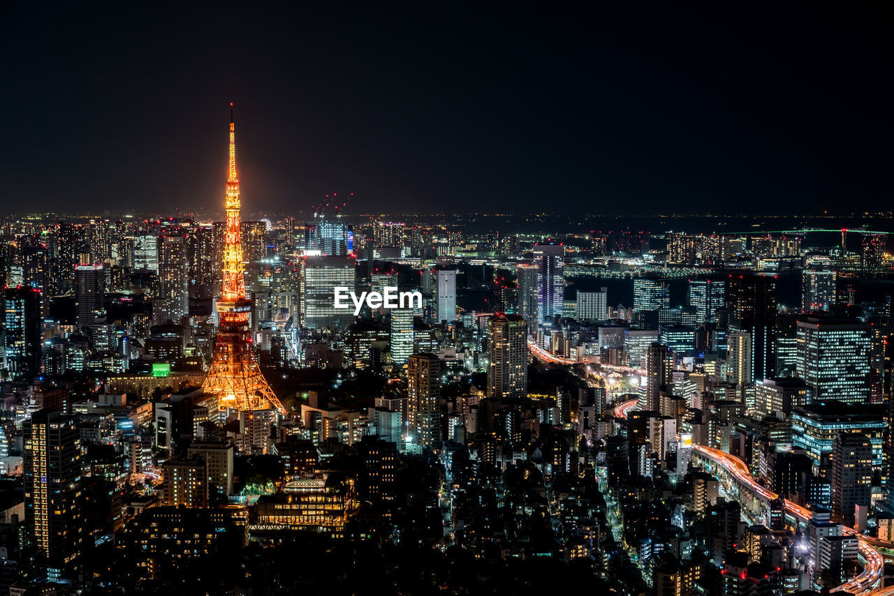 ILLUMINATED CITY BUILDINGS AT NIGHT