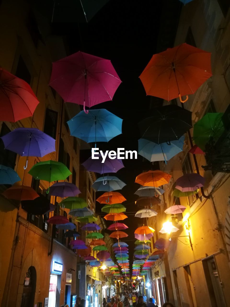 LOW ANGLE VIEW OF ILLUMINATED LANTERNS HANGING ON CLOTHESLINE