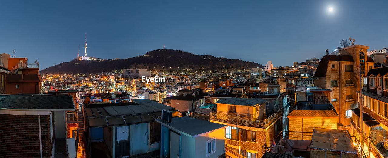 high angle view of illuminated buildings against sky at night