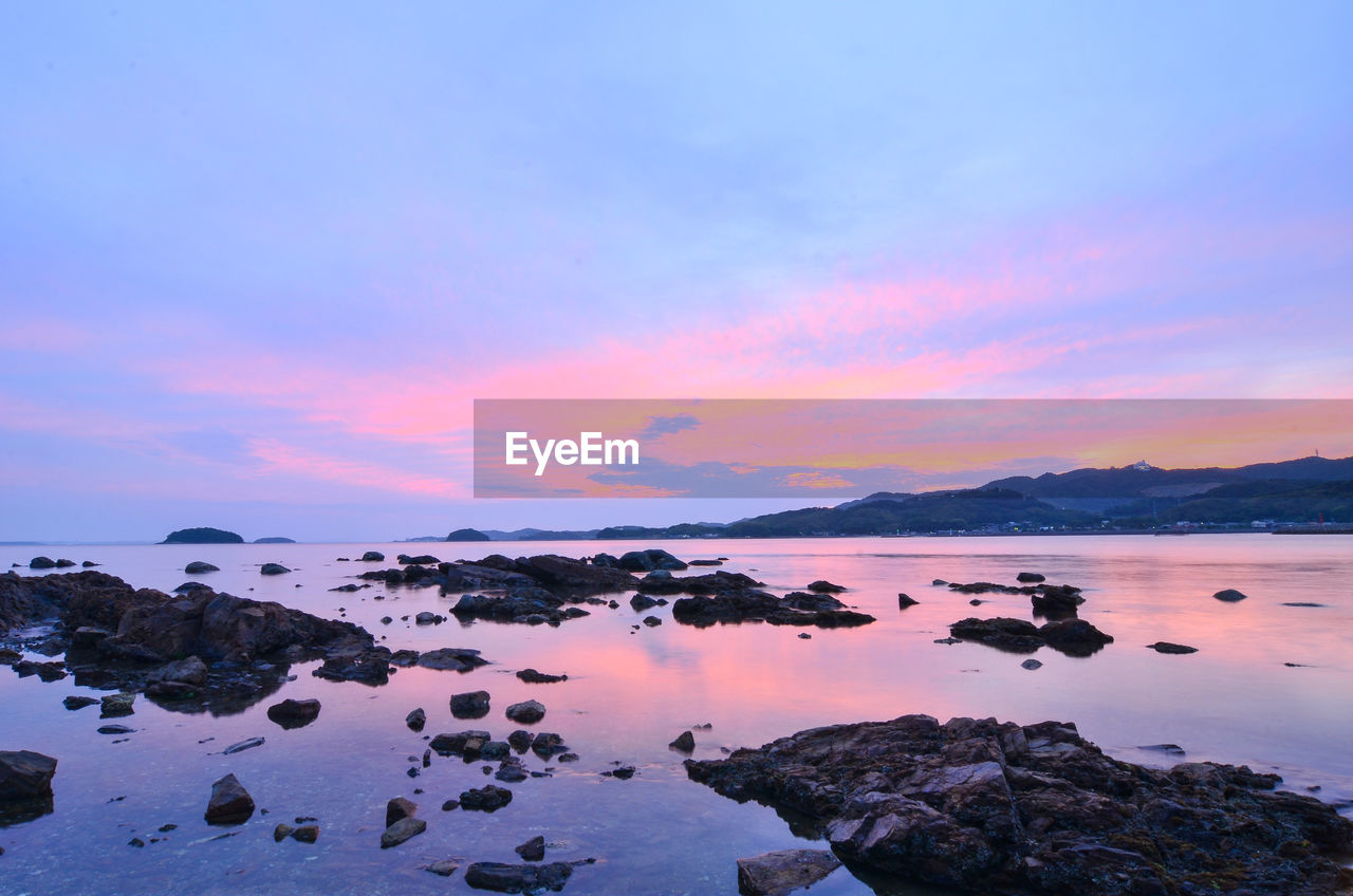 Scenic view of lake against sky during sunset