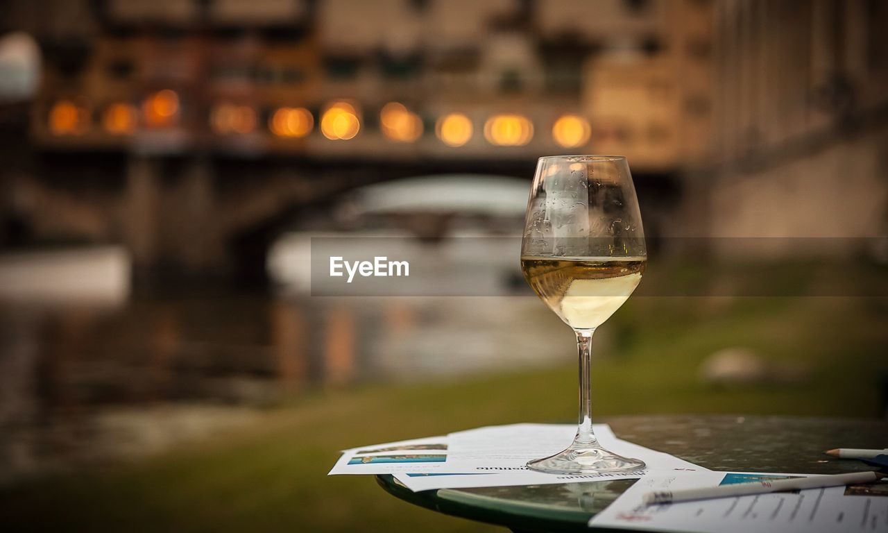 Wine on table against bridge over river