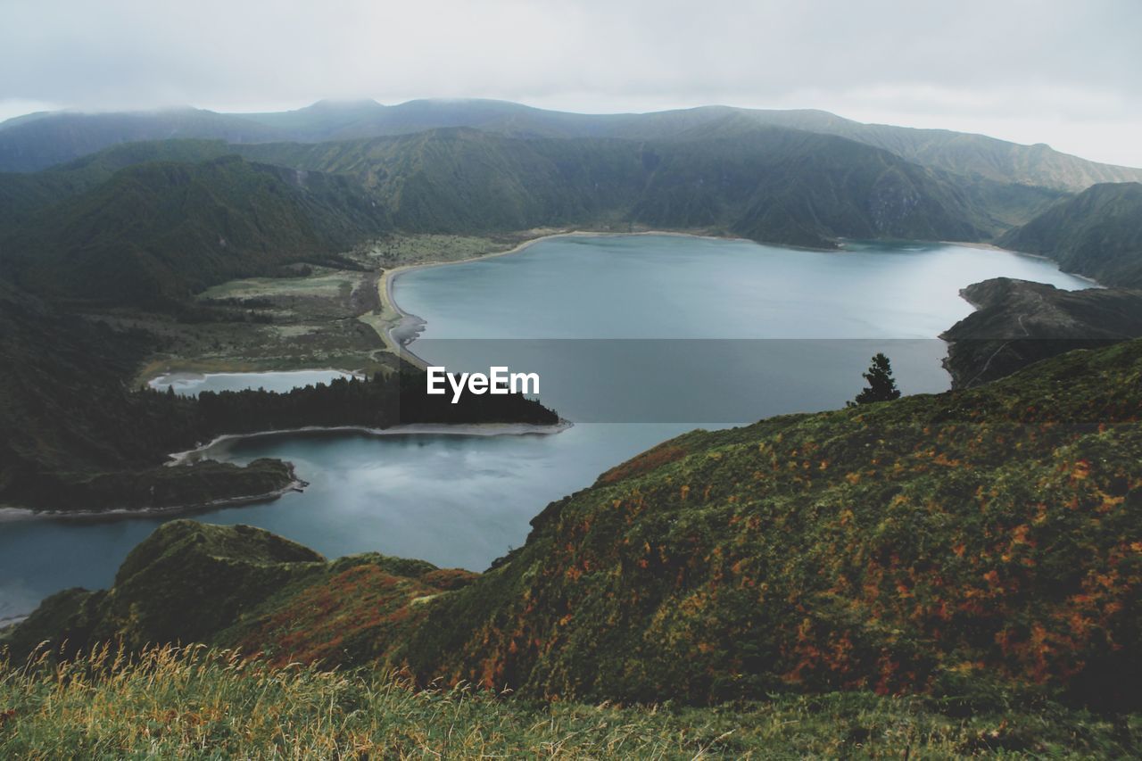 Scenic view of lake amidst mountains against sky