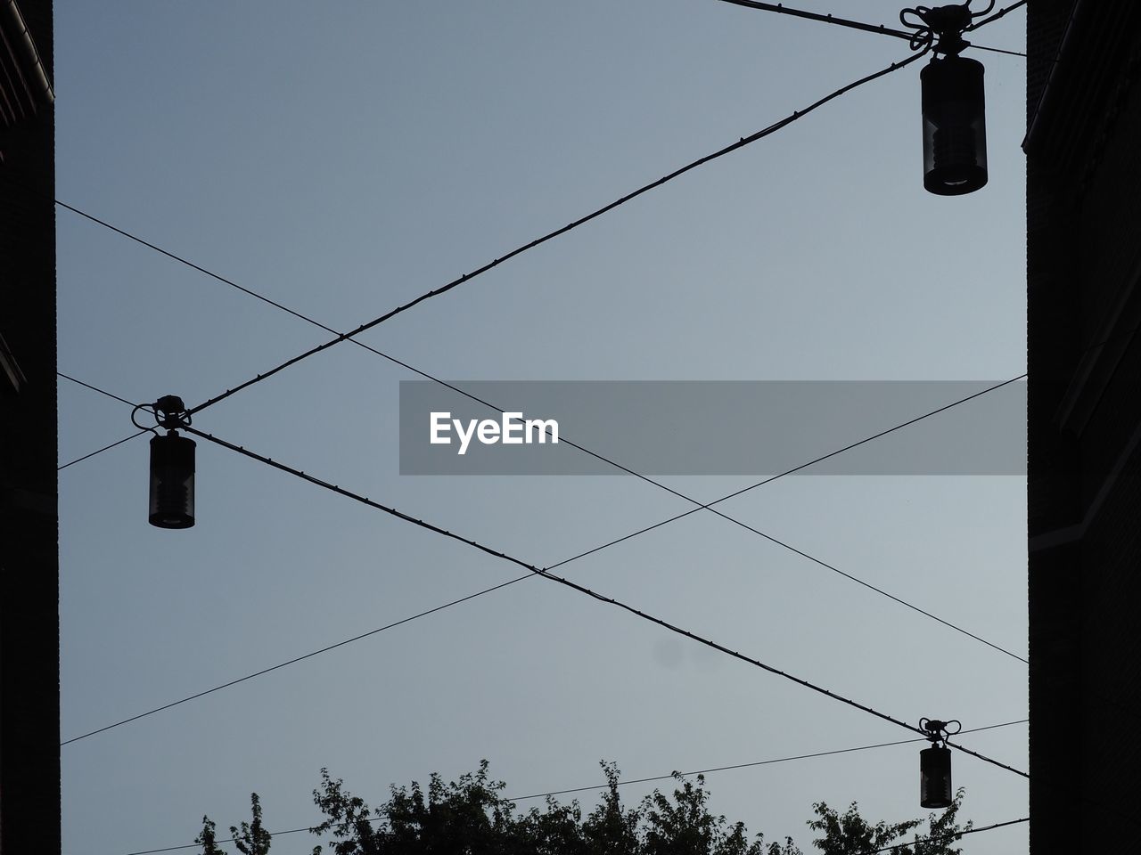 LOW ANGLE VIEW OF POWER CABLES AGAINST SKY