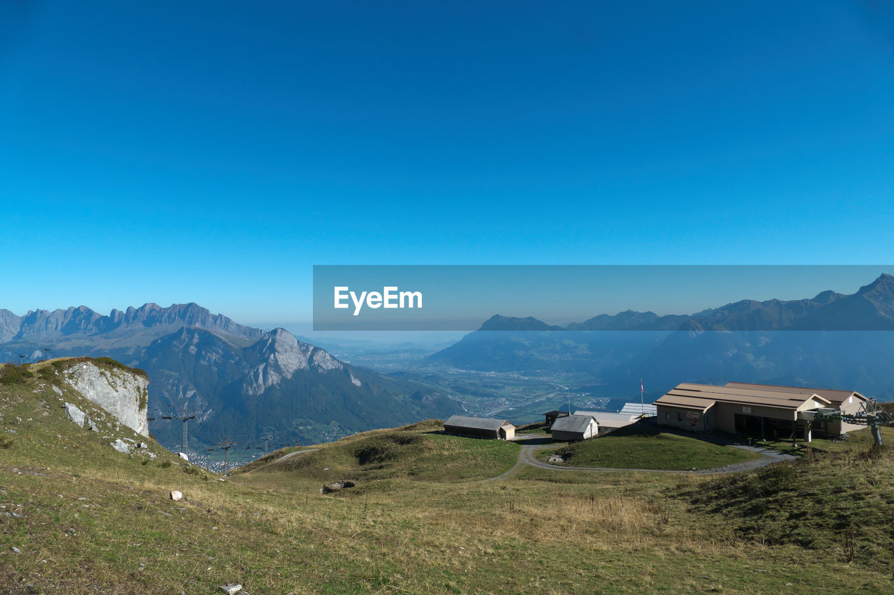 Scenic view of mountains against clear blue sky