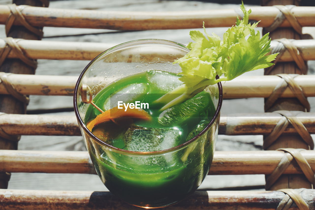 High angle close-up of juice on wooden table during sunny day