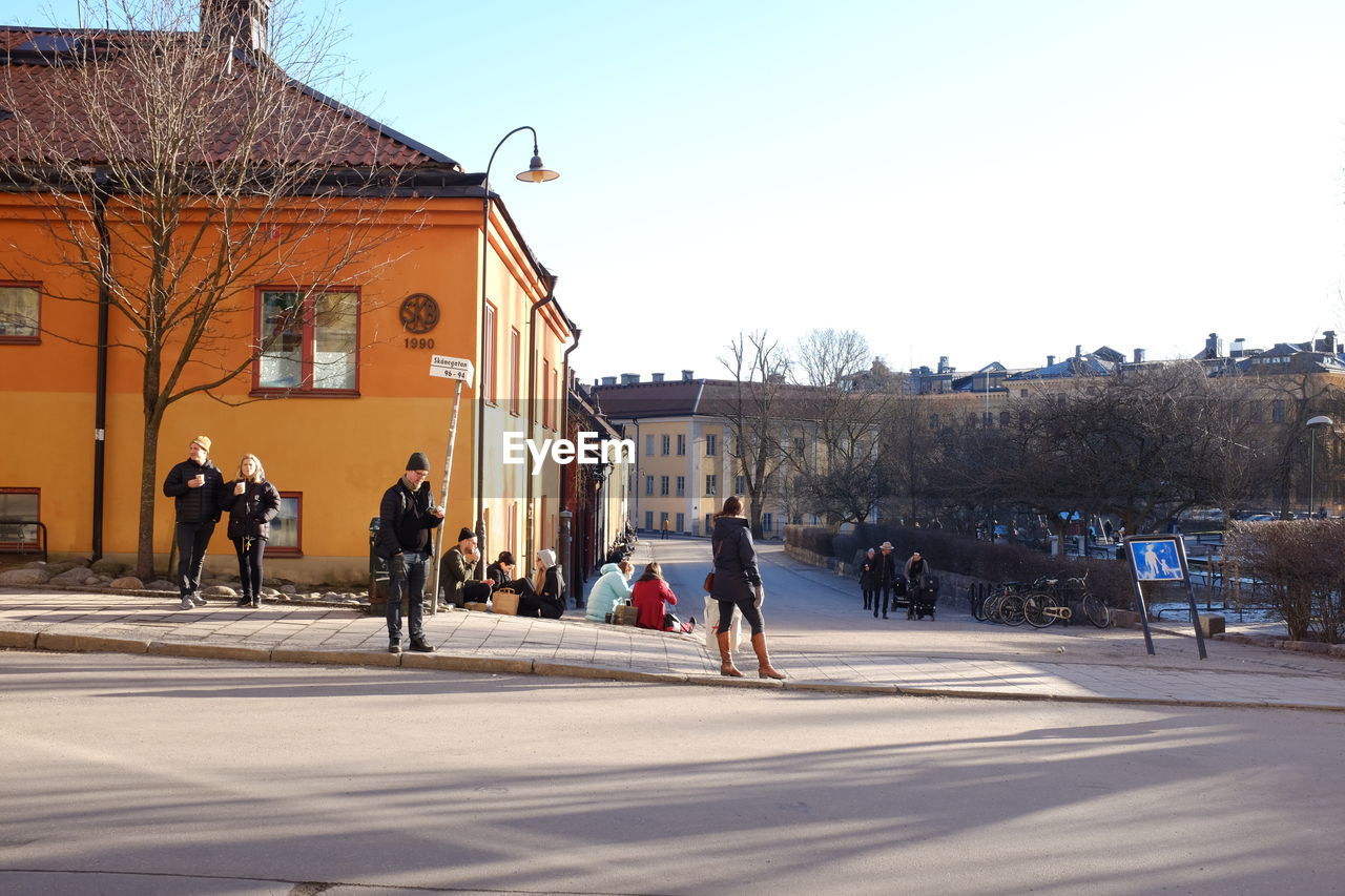 PEOPLE IN FRONT OF BUILT STRUCTURES