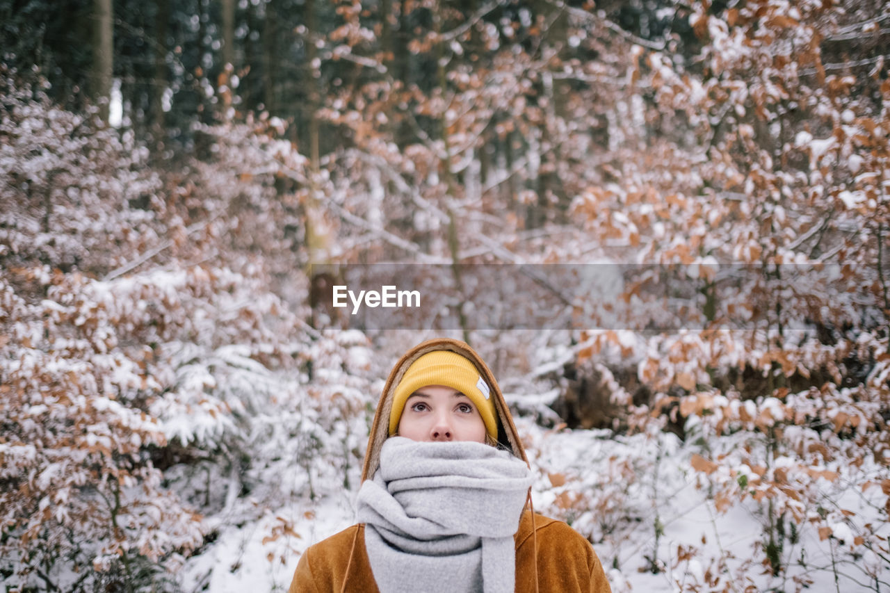 Woman in snow covered forest