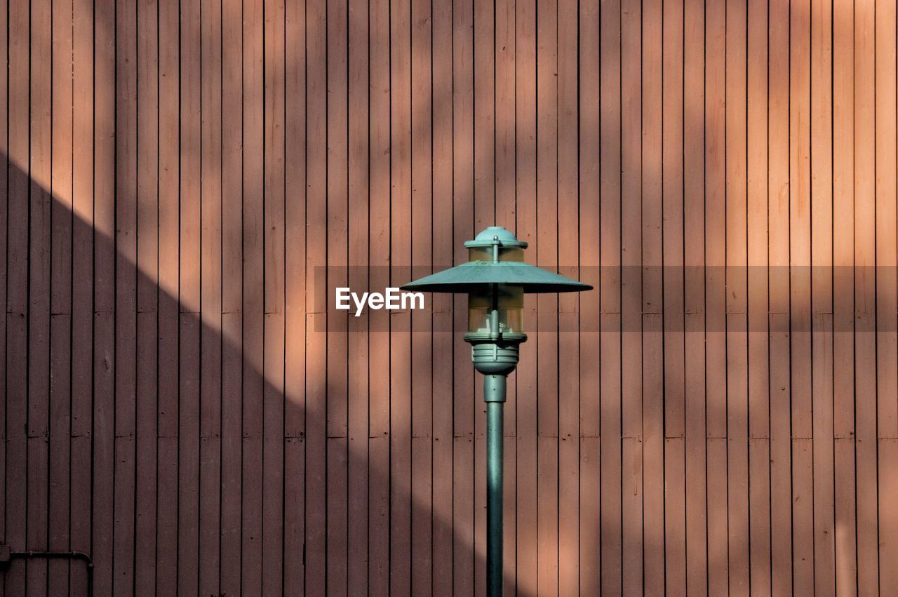 Close-up of electric lamp on wall