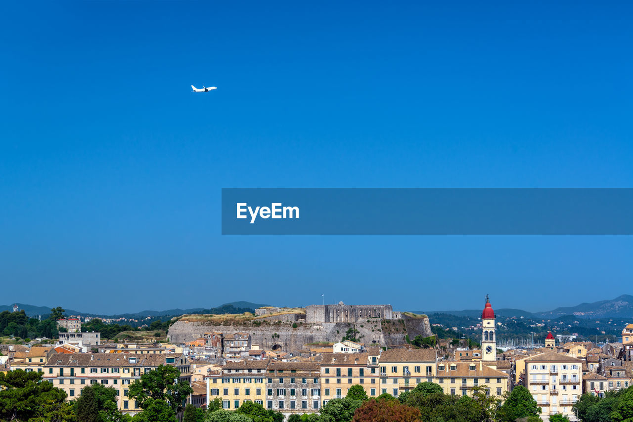 TOWNSCAPE AGAINST CLEAR BLUE SKY