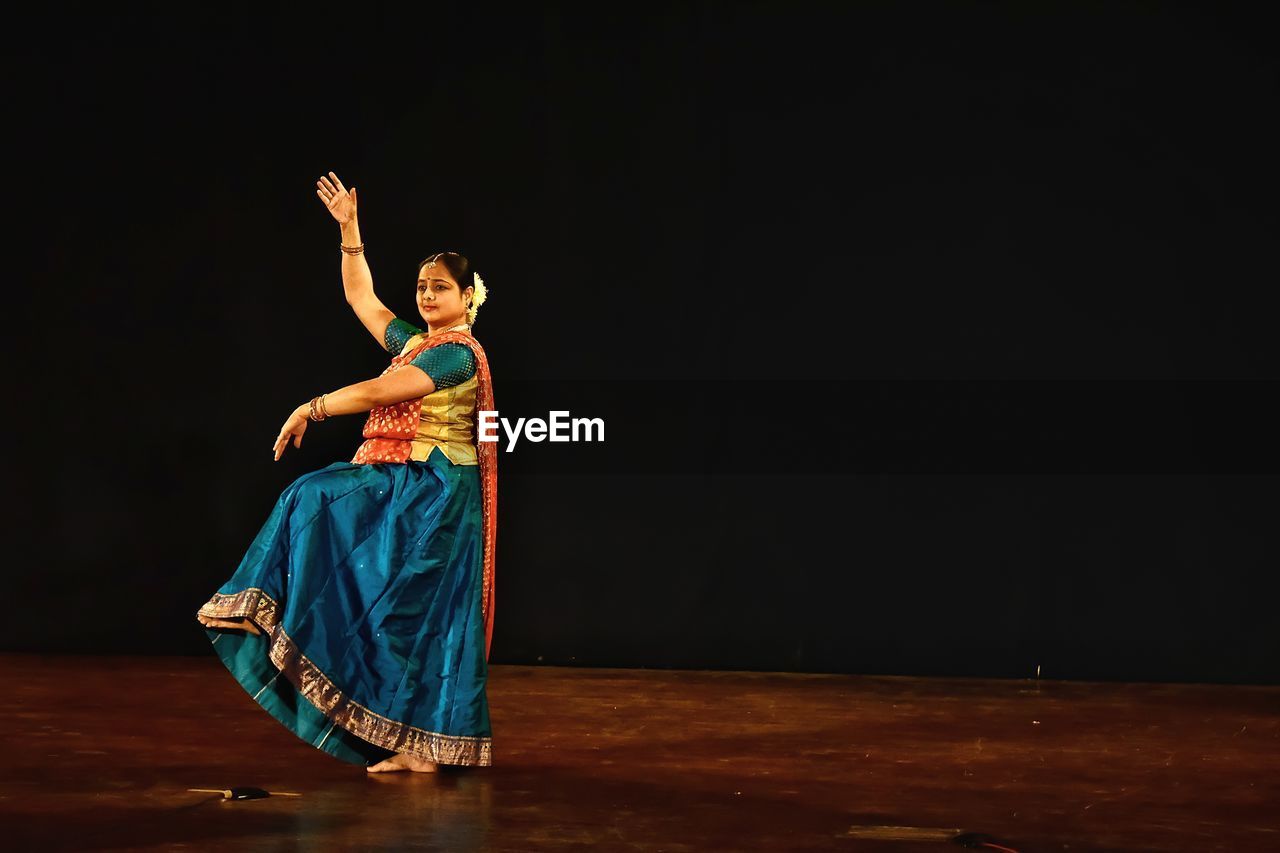 Woman performing kathak on stage