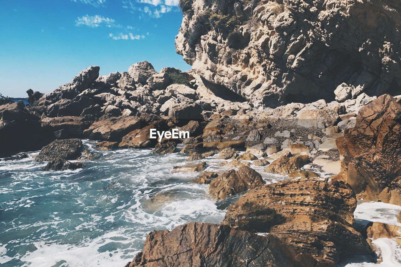 Close-up of sea against sky and rocks