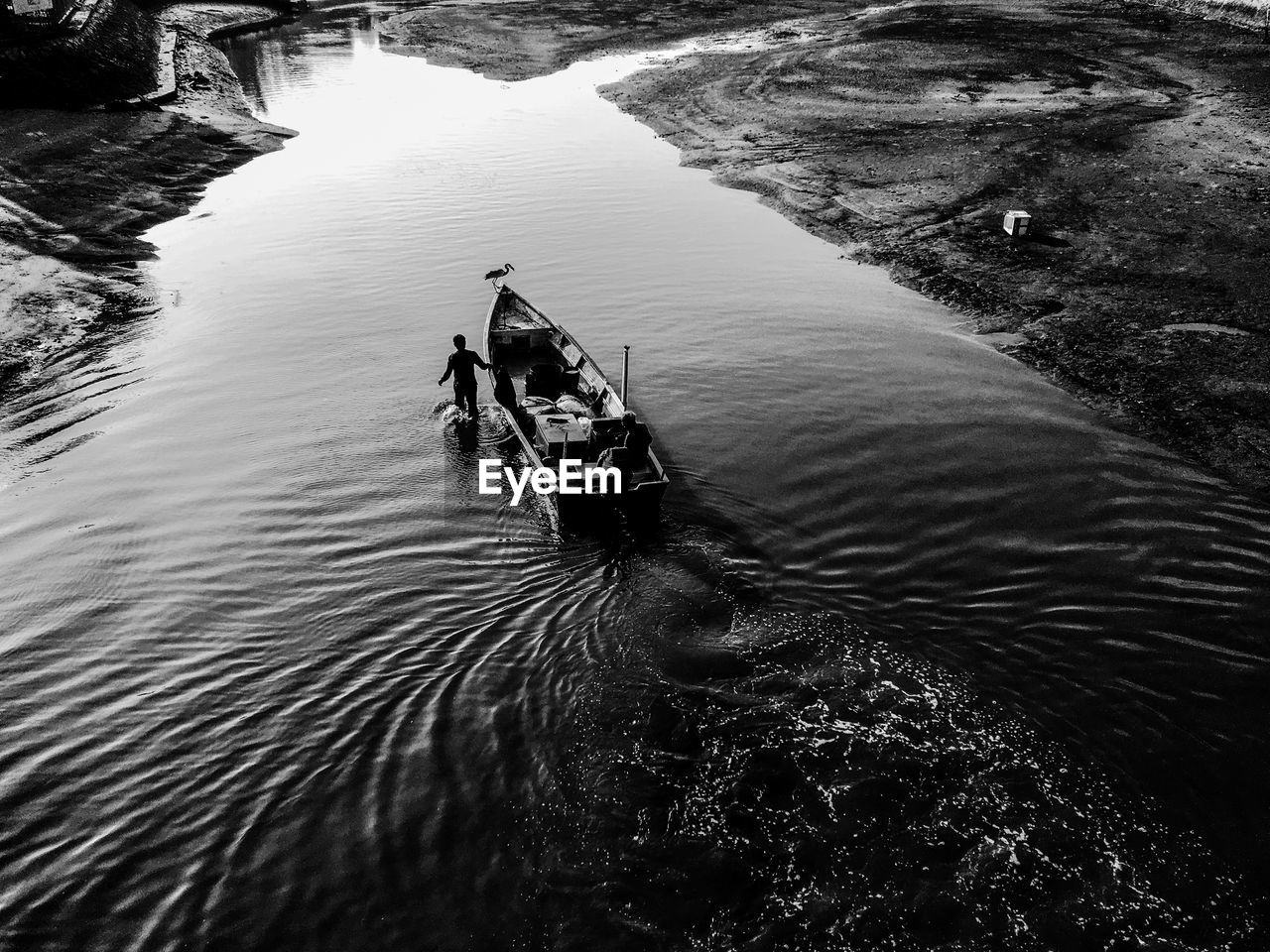 High angle view of men with boat over river