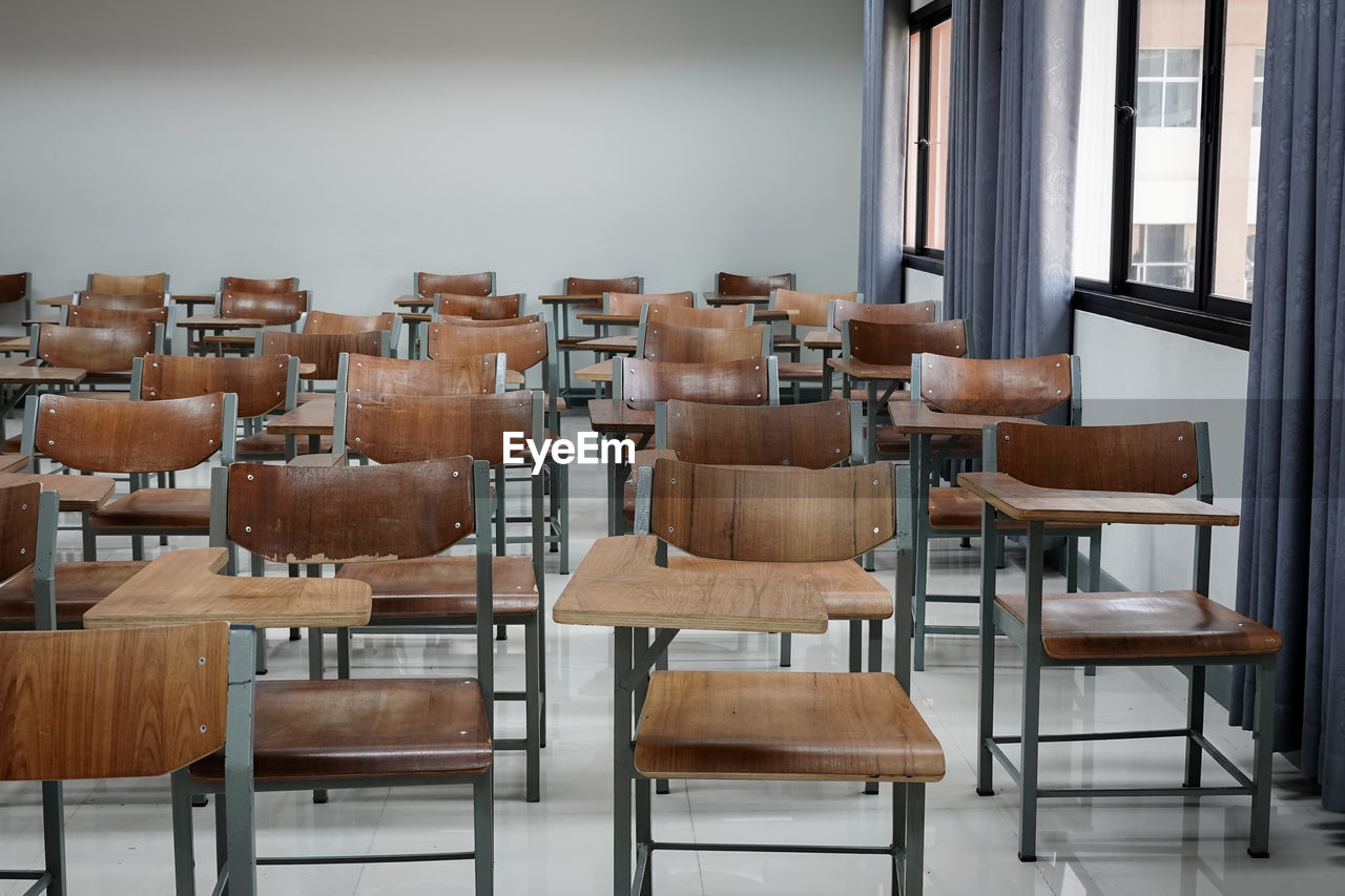 Empty chairs and table in classroom