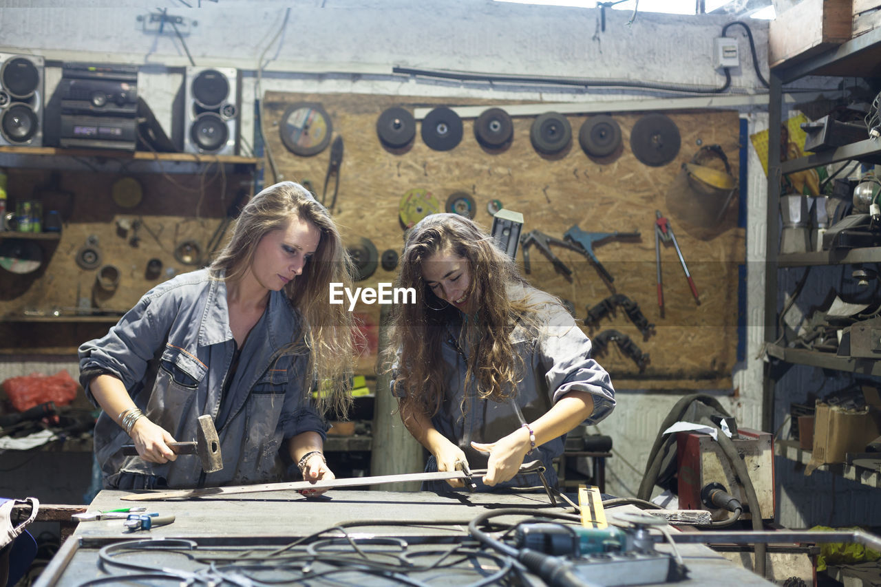 Female mechanics working in workshop