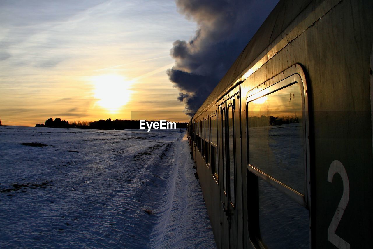 Scenic view of train against sky during sunset