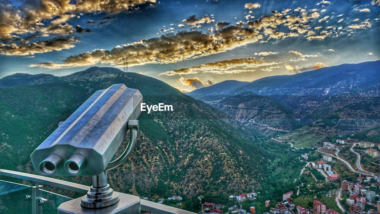 Aerial view of city and mountains against sky