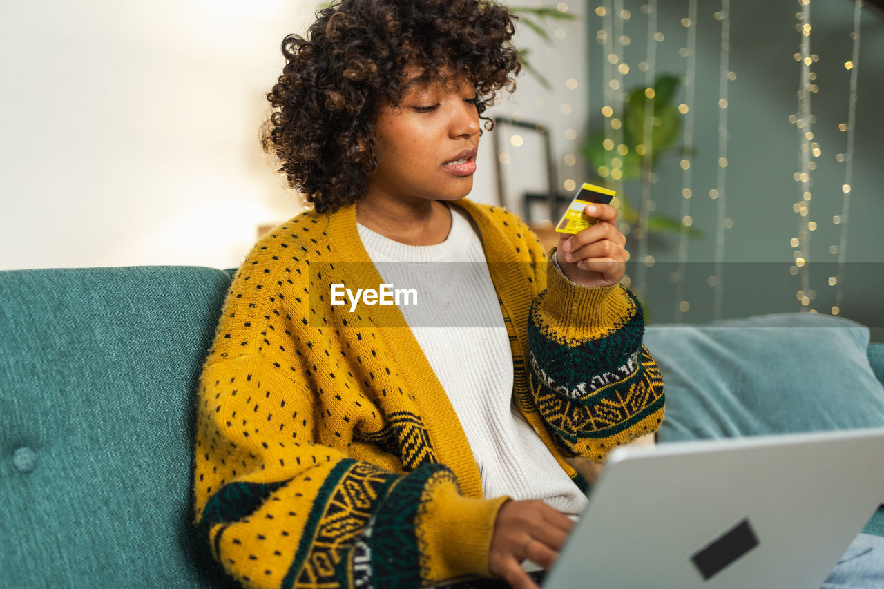 portrait of woman using laptop while sitting on table