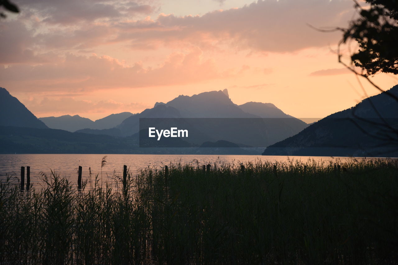 Scenic view of silhouette mountains against sky during sunset