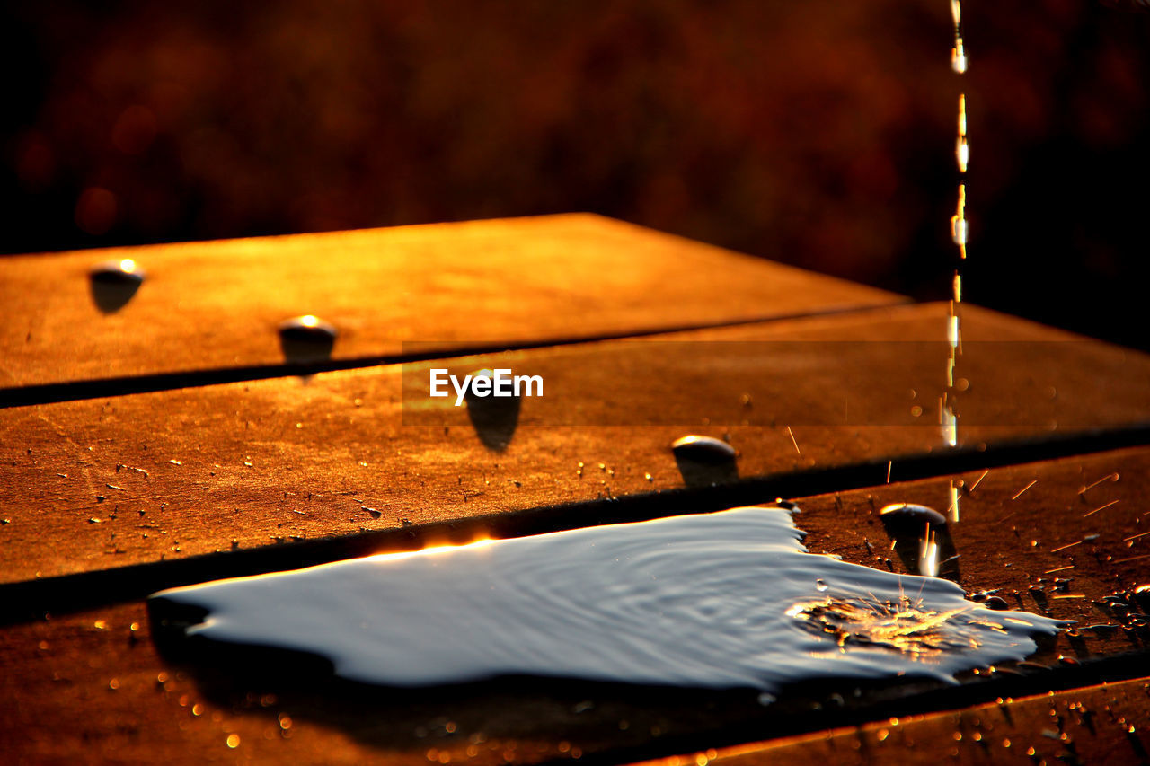 Close-up of liquid falling on table