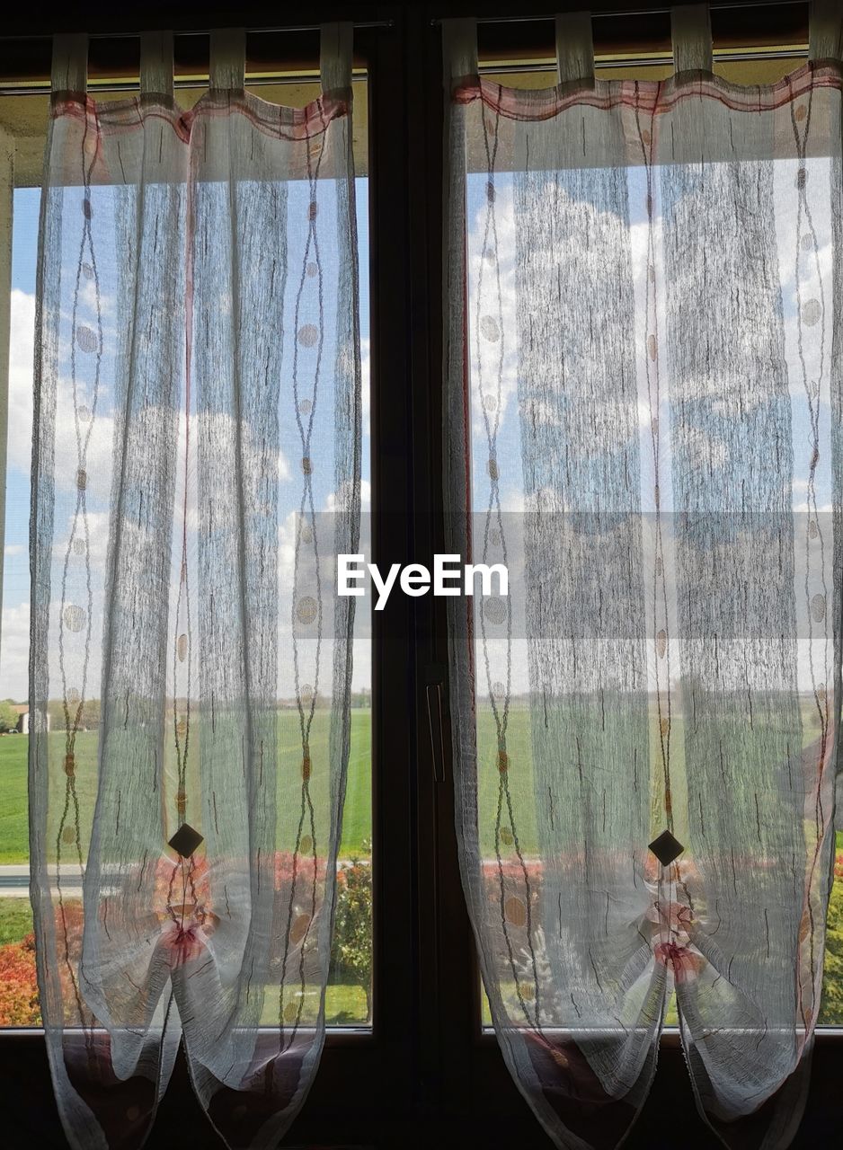 REFLECTION OF PEOPLE ON GLASS WINDOW WITH CURTAIN