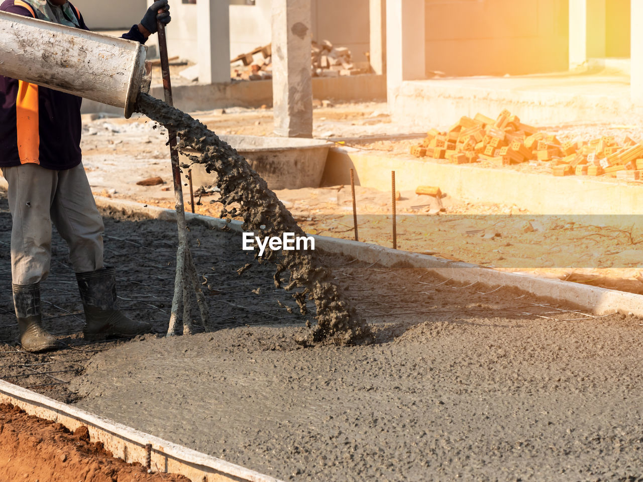 Mixed concrete pouring at construction site on the road