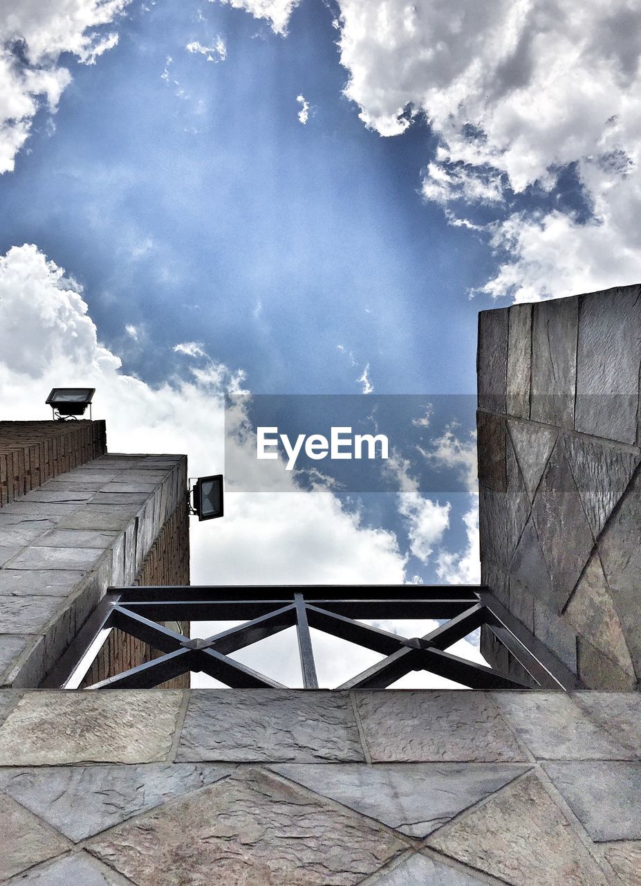 Low angle view of old building against cloudy sky