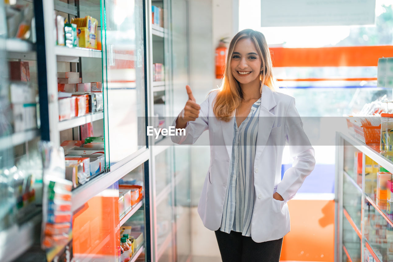 portrait of young woman standing in store