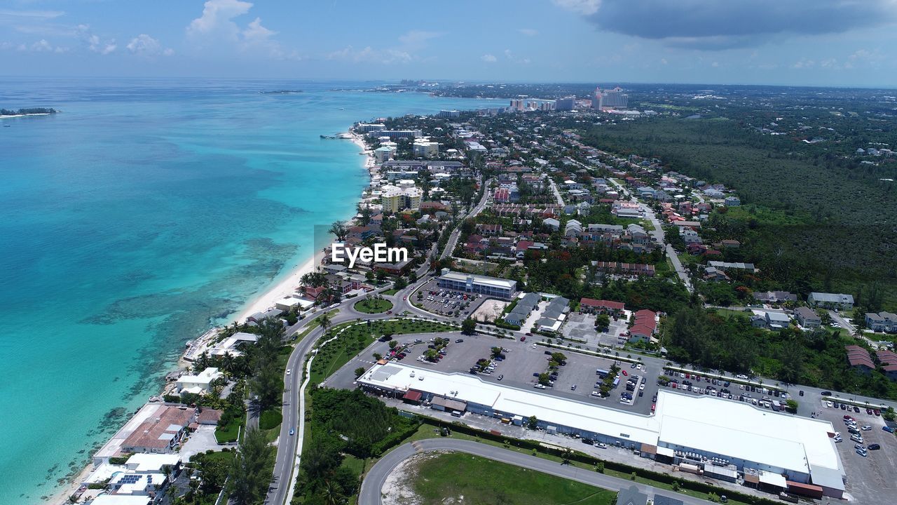 High angle view of buildings by sea against sky