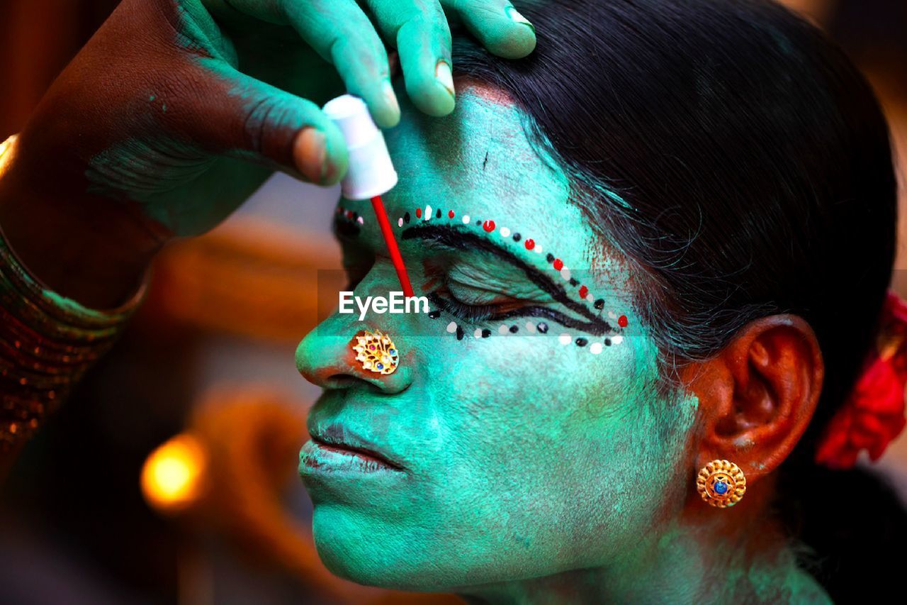 Close-up of woman wearing face paint