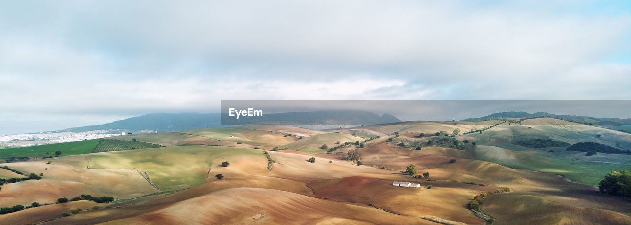 Scenic view of landscape and mountains against sky