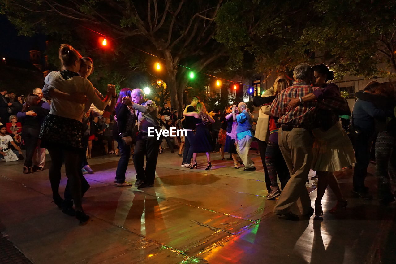 People tangoing during celebration at night