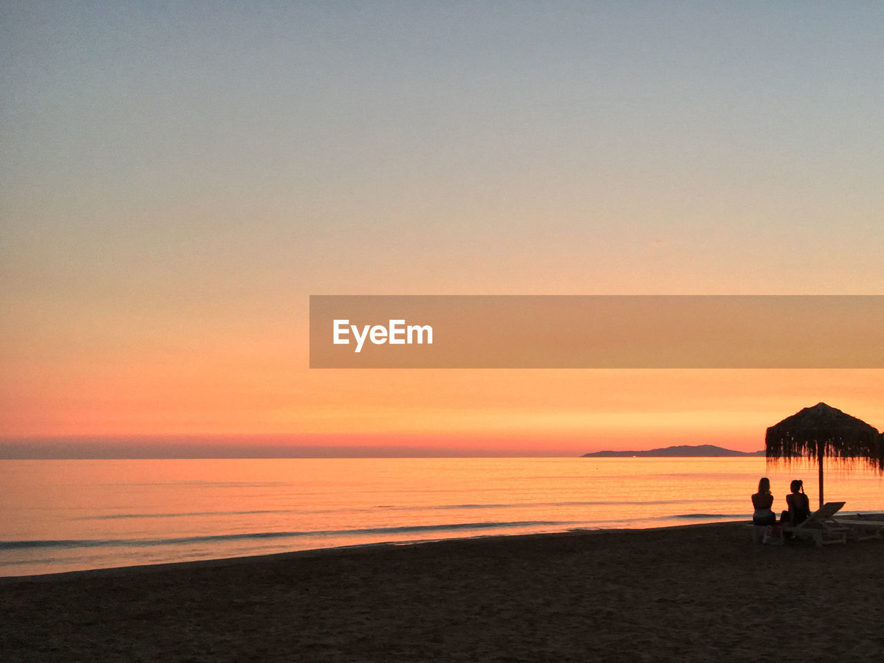 SCENIC VIEW OF BEACH DURING SUNSET