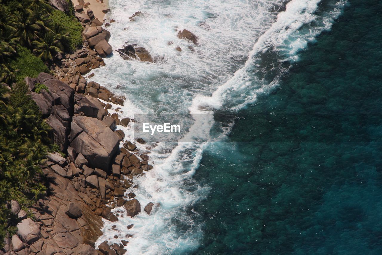 High angle view of rocks in sea