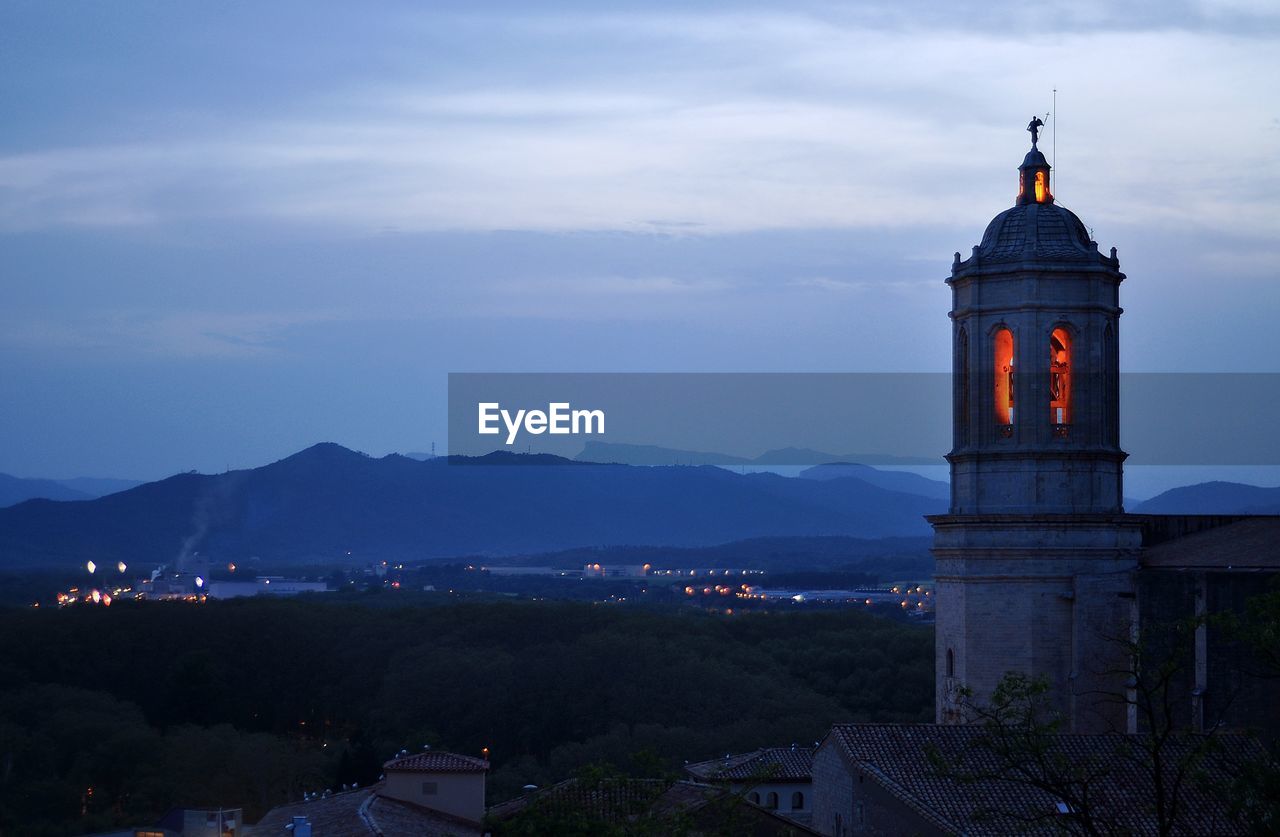 Tower amidst buildings in city against sky