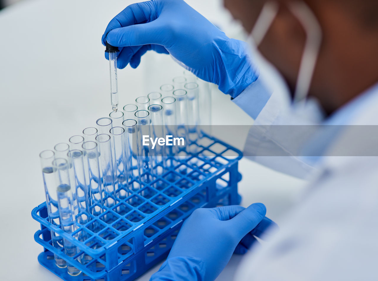 cropped hand of scientist examining chemical in laboratory