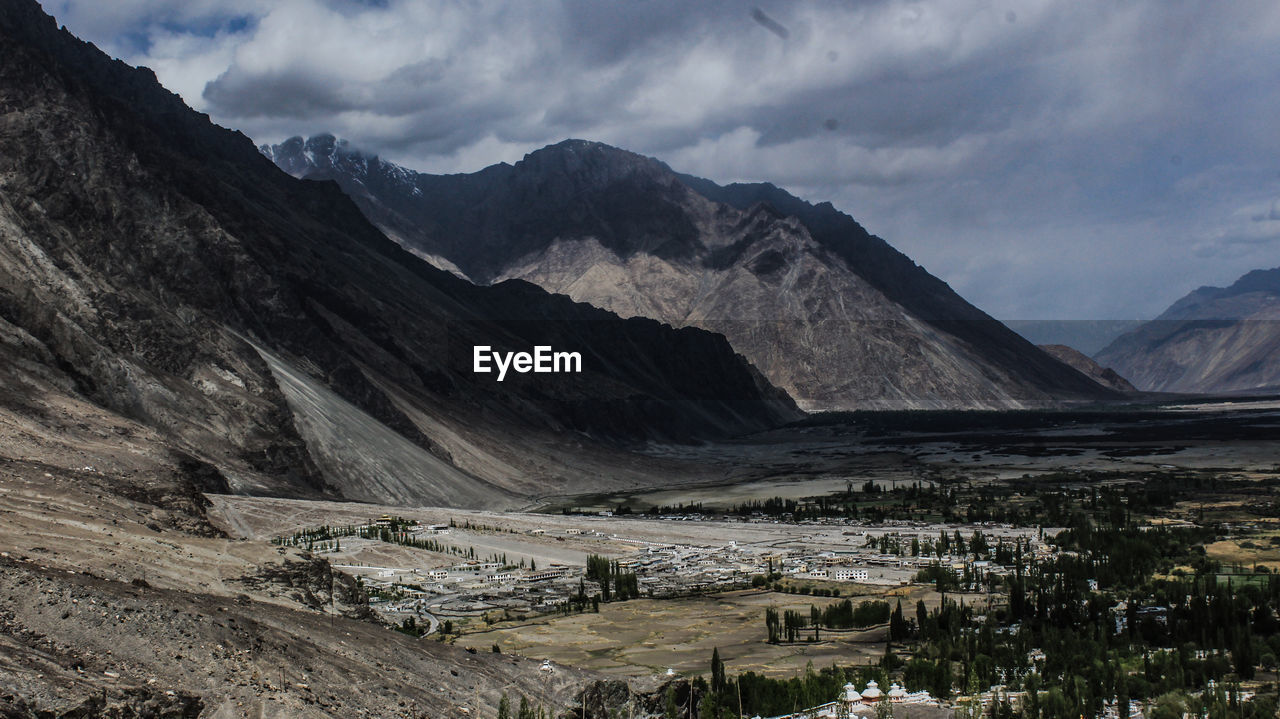 High angle view of snowcapped mountains against sky