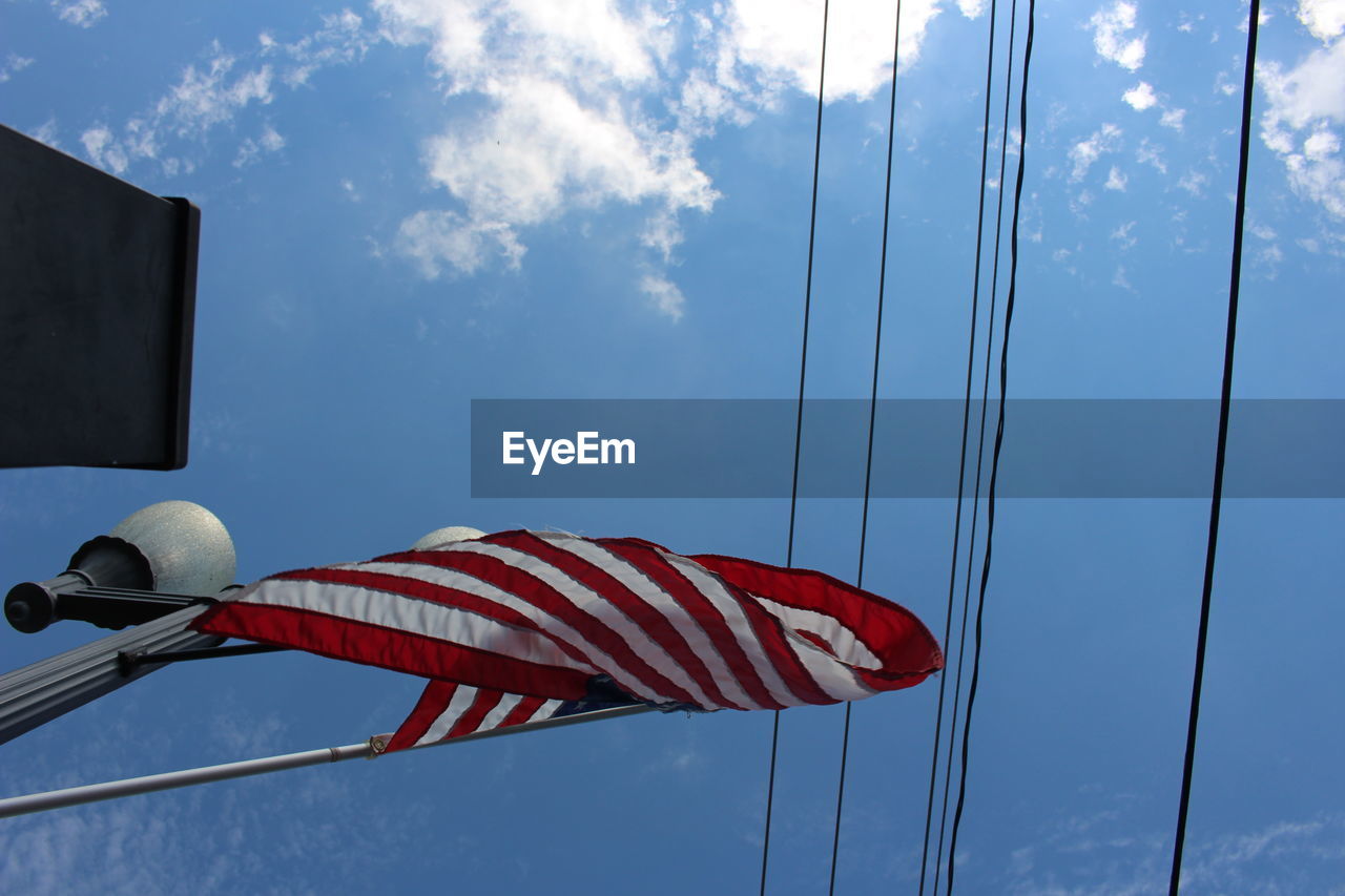 LOW ANGLE VIEW OF FLAG AGAINST BLUE SKY