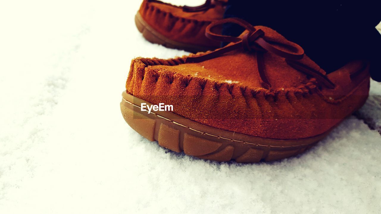 Close-up of shoes on snow