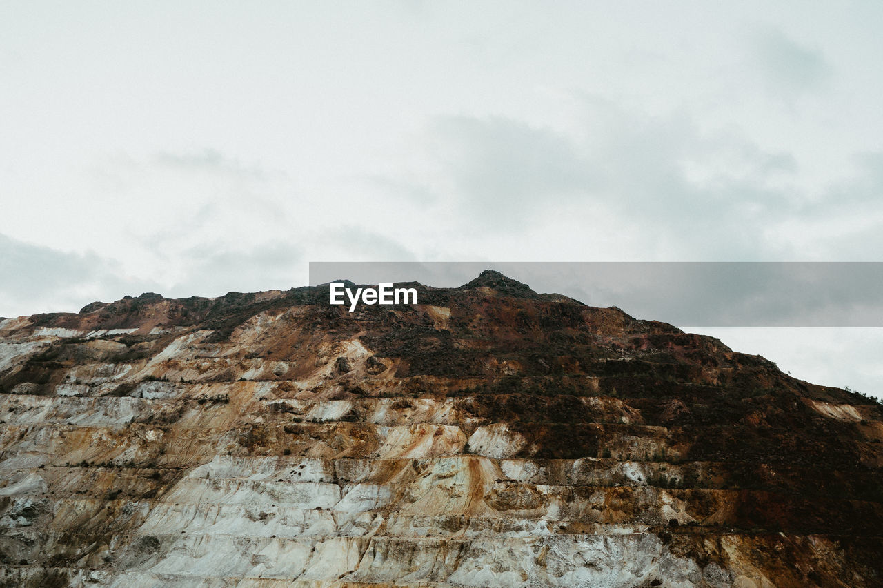 LOW ANGLE VIEW OF ROCK FORMATION AGAINST SKY