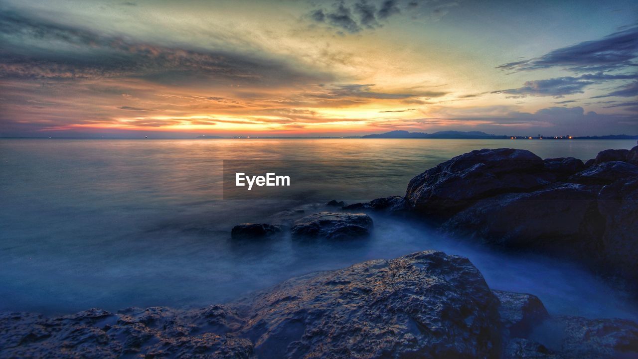 Scenic view of sea against sky during sunset