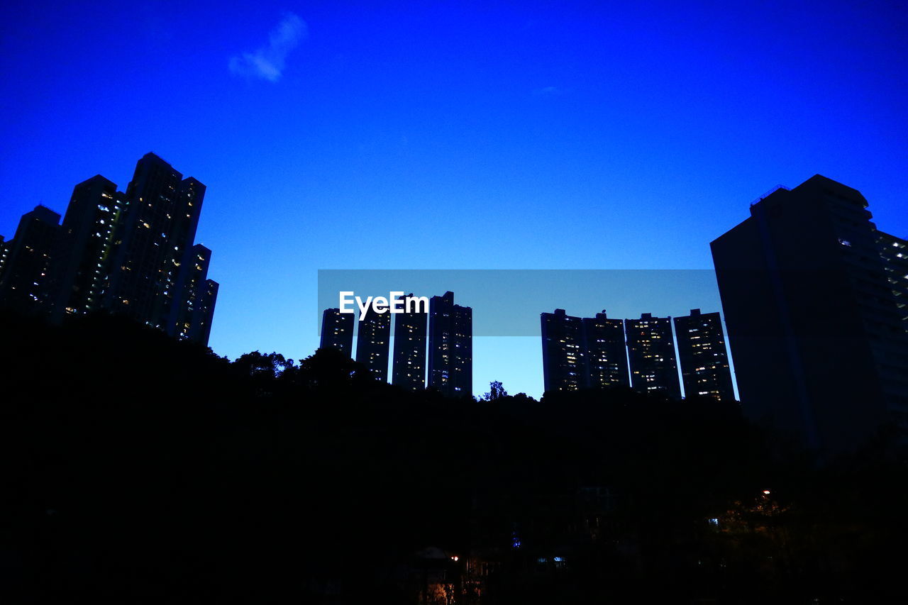 LOW ANGLE VIEW OF BUILDINGS AGAINST BLUE SKY