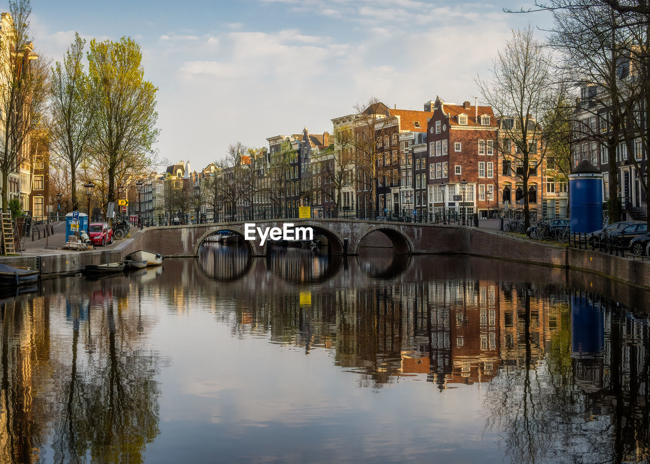 View over keizersgracht canal and the historic arch bridge and canal houses on a spring evening.