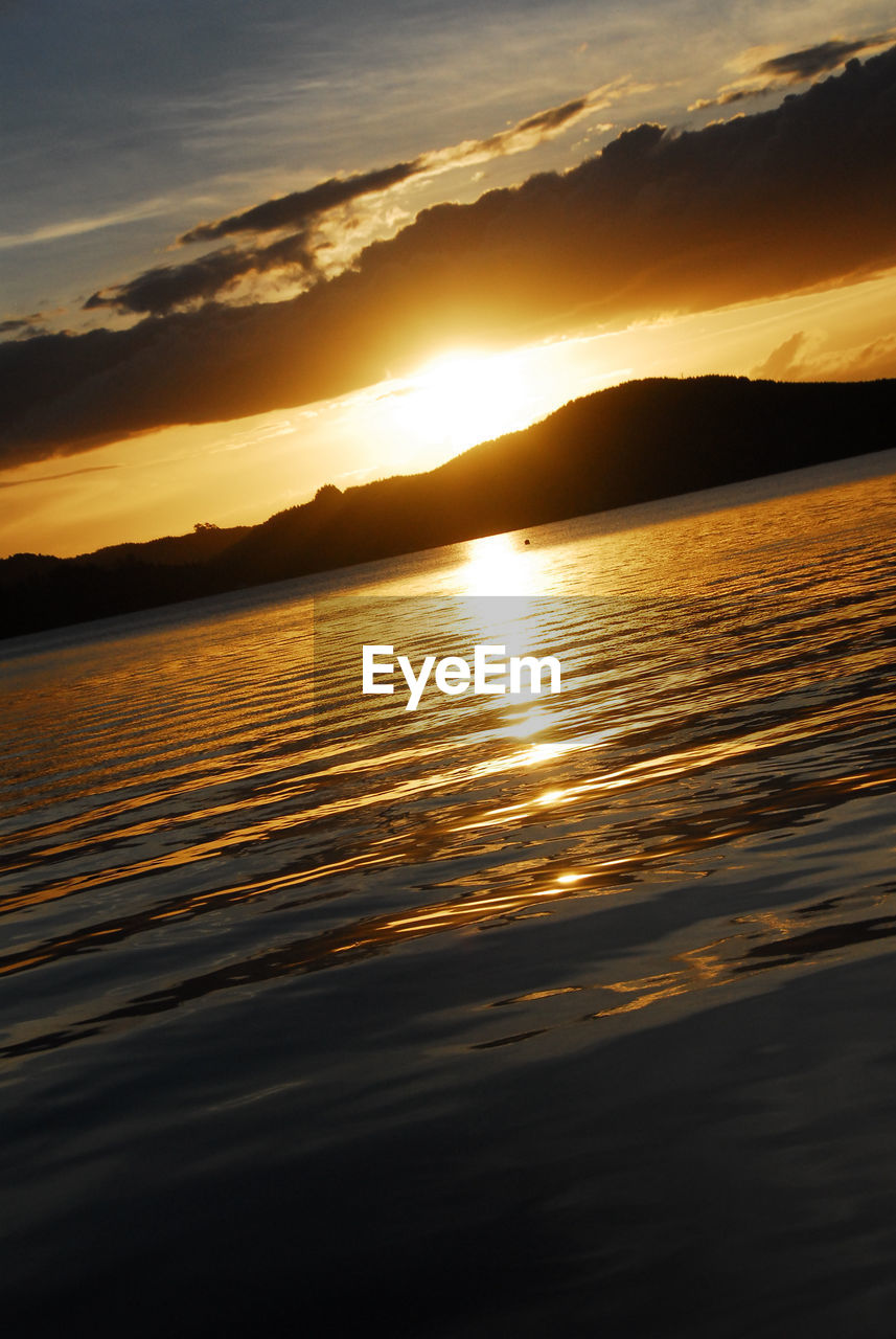 SCENIC VIEW OF SEA AGAINST ORANGE SKY