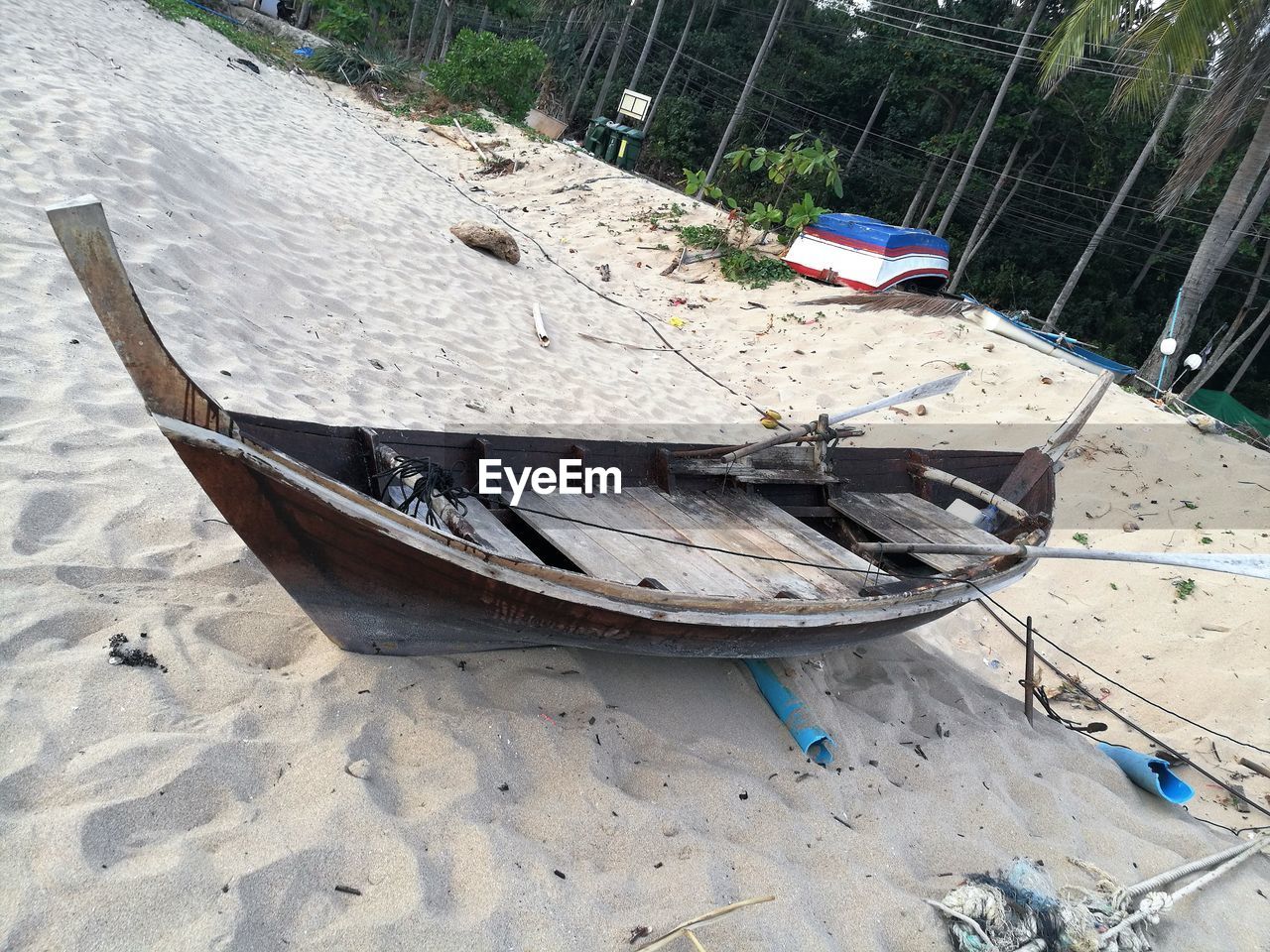 HIGH ANGLE VIEW OF FISHING BOAT ON BEACH