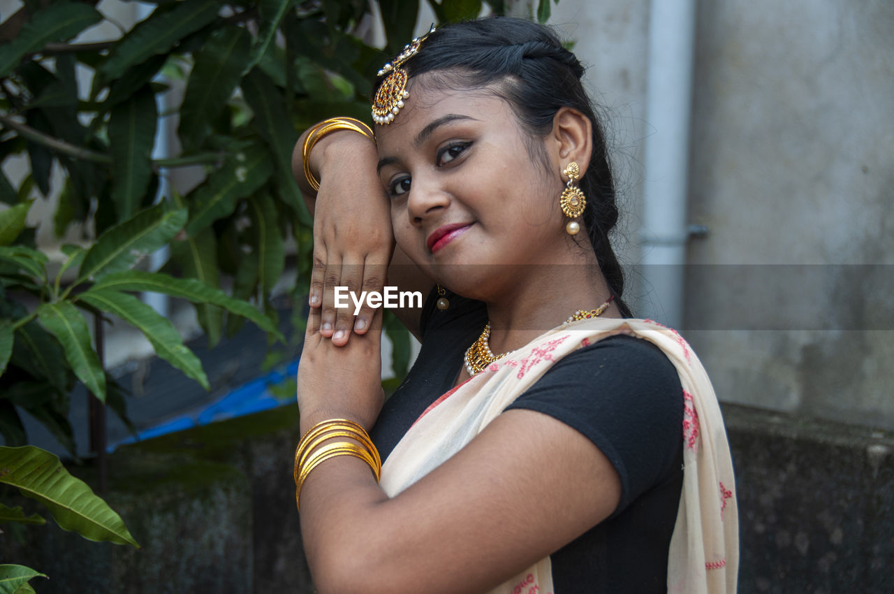 A teenage girl practicing bharatnatyam in nature