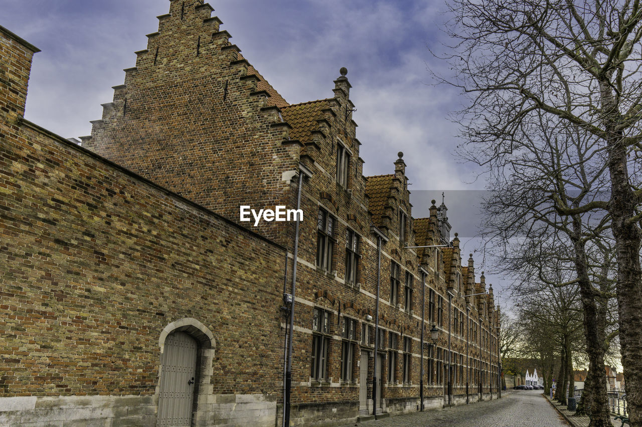 architecture, built structure, building exterior, history, the past, building, travel destinations, sky, nature, tree, city, château, travel, no people, old, tourism, castle, outdoors, cloud, day, street, plant, place of worship, bare tree, wall, religion, tower