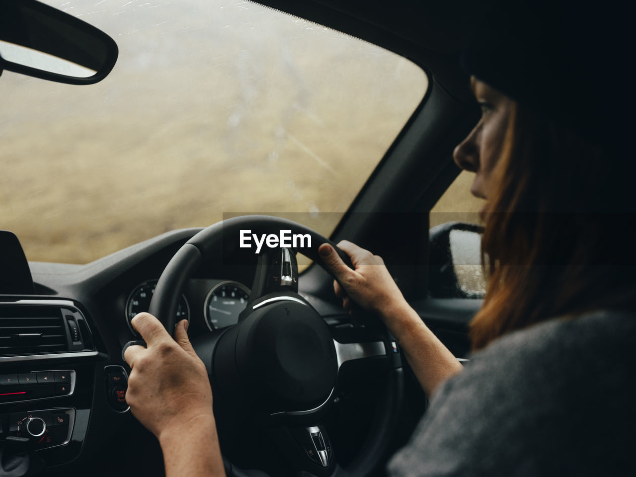 Woman driving car through glen etive