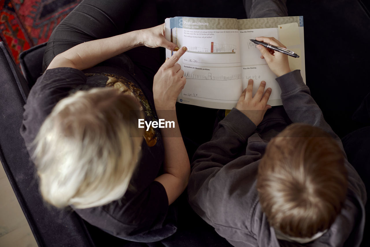 Mother helping son with homework